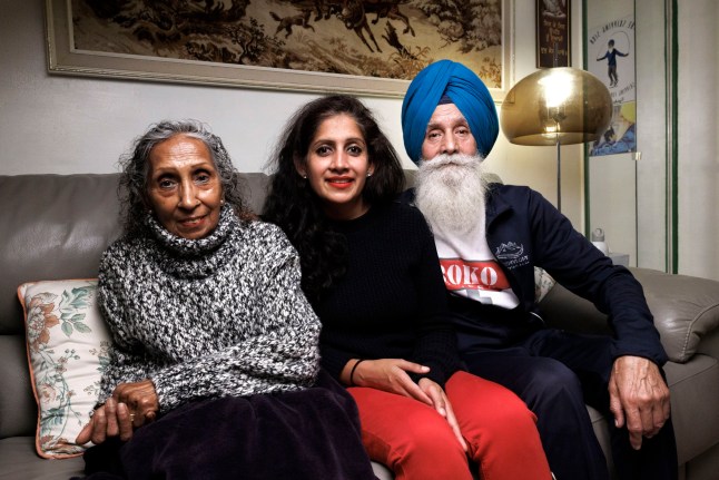Minreet Kaur, who lives at home in London, is pictured with her parents on the sofa