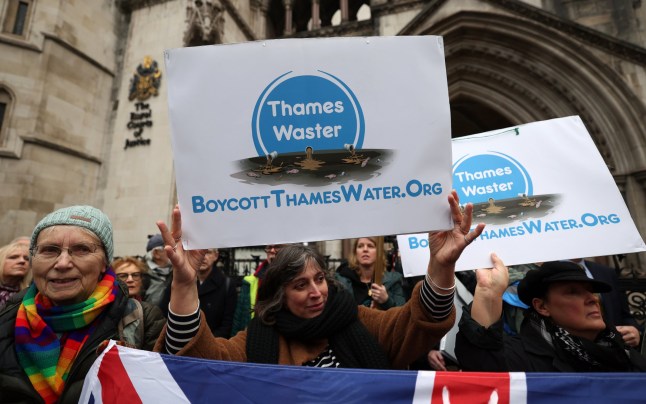 epa11782230 Protesters carry placards during a Thames Water bailout protest at the High Court in London, Britain, 17 December 2024. Protesters gathered outside London???s High Court against a Thames Water bailout that would see customers pay an extra 250 British pounds a year to rescue the failing water company. EPA/ANDY RAIN