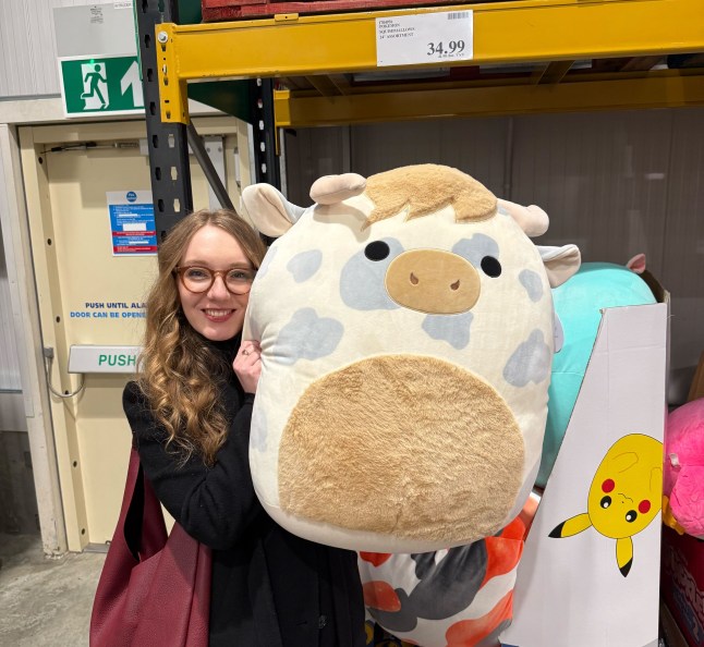 Courtney Pochin holding a giant Squishmallow in Costco