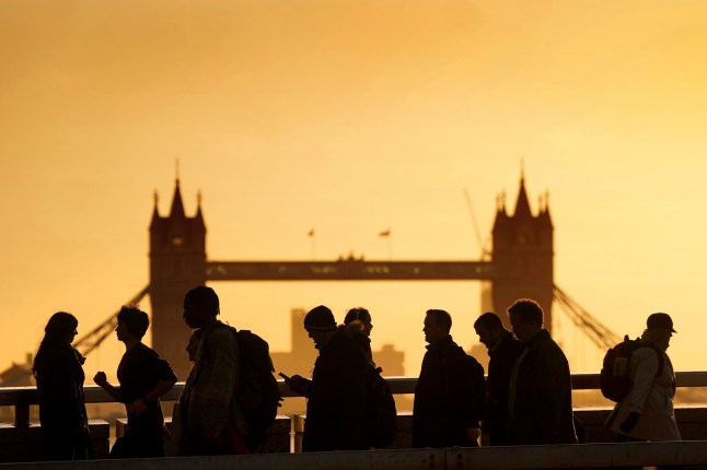 Commuters battle strong winds on London Bridge. Thousands of people have been left without power as Storm Isha brought disruption to the electricity and transport networks across the UK. Picture date: Monday January 22, 2024. PA Photo. The Met Office said the highest recorded wind speed during Storm Isha was 99mph at Brizlee Wood in Northumberland with gusts of 90mph at Capel Curig in Snowdonia on Sunday. See PA story WEATHER Isha. Photo credit should read: Victoria Jones/PA Wire
