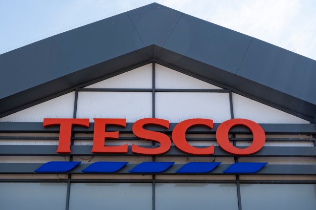 Tesco supermarket logo outise the store on Old Kent Road on 8th May 2024 in London, United Kingdom. Tesco plc is a global grocery and general merchandise retailer headquartered in the United Kingdom. It is the third-largest retailer in the world measured by revenues and the second-largest measured by profits. It has stores in 14 countries across Asia, Europe and North America and is the grocery market leader in the UK where it has a market share of around 30%. The company was founded by Jack Cohen in 1919 and opened its first store in 1929. It is a controversial success story in retail as it is often accused of strangling the market and pushing out smaller businesses and retailers. (photo by Mike Kemp/In Pictures via Getty Images)
