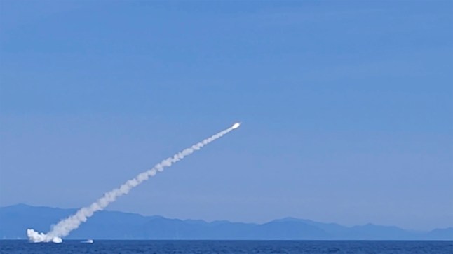 Vladimir Putin staged war games in a warning to the West as his Pacific Fleet submarine Ufa launched Kalibr cruise missiles during exercises in the Sea of Japan.