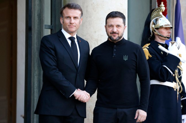 France's President Emmanuel Macron (L) greets Ukraine's President Volodymyr Zelensky at the Elysee Palace in Paris on March 26, 2025 to prepare for the summit with the 'coalition of the willing'. The summit of the "coalition of the willing" is held in Paris on March 27, 2025. (Photo by Ludovic MARIN / AFP) (Photo by LUDOVIC MARIN/AFP via Getty Images)