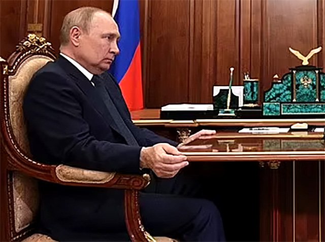 A grimacing Vladimir Putin is seen tightly gripping his desk as his most trusted general reports to him with a straight face that invaded Ukrainians are showing their 'support' for occupying Russian soldiers, August 30 2022 Picture: EPA