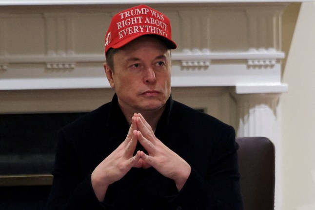 FILE PHOTO: Tesla CEO Elon Musk wears a 'Trump Was Right About Everything!' hat while attending a cabinet meeting at the White House, in Washington, D.C., U.S., March 24, 2025. REUTERS/Carlos Barria/File Photo