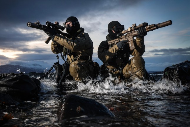 Undated handout Ministry of Defence of Royal Marine Commandos take up position on a beach in Harvstad, Norway