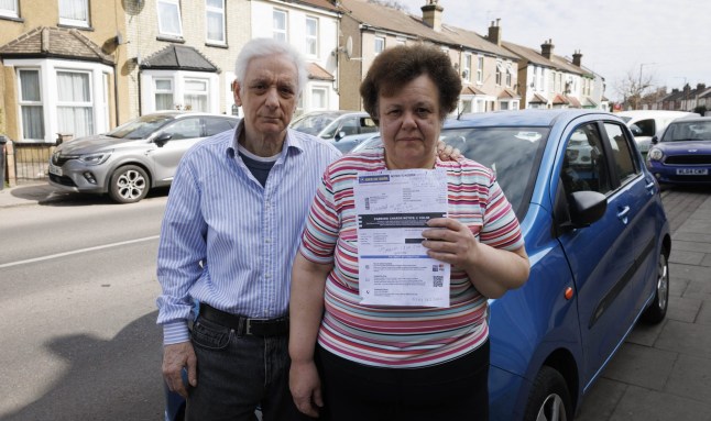 A man and his wife with a parking ticket they got from Euro Car Parks in Enfield.