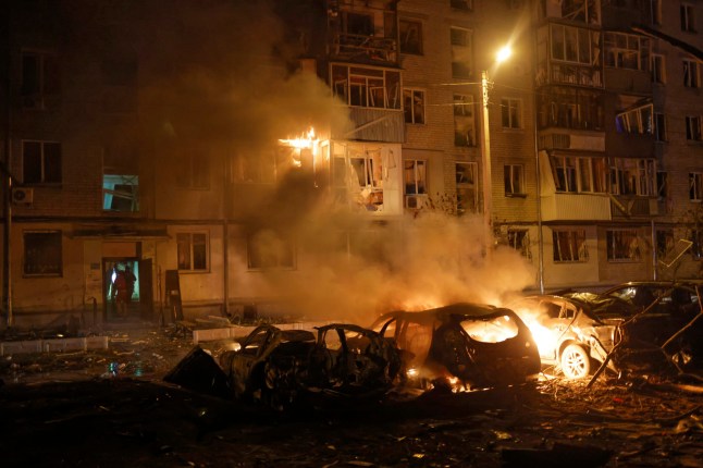 Firefighters put out the fire following Russia's drone attack in Kharkiv, Ukraine, late Thursday, April 3, 2025. (AP Photo/Yevhen Titov)
