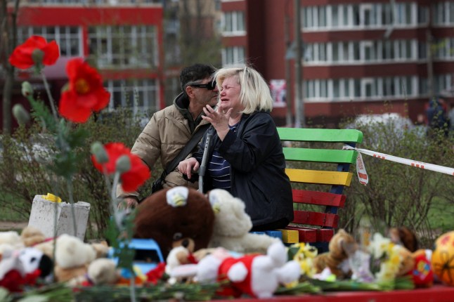 A woman reacts at the site of a deadly Russian missile strike on a residential area that killed multiple children and adults, amid Russia's attack on Ukraine, in Kryvyi Rih, Ukraine, April 5, 2025. REUTERS/Violeta Santos Moura