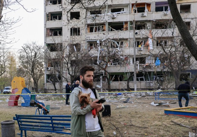 epa12038482 People inspect the site of a rocket attack near a high-rise building in a residential area in Kharkiv, Ukraine, 18 April 2025, amid the ongoing Russian invasion. At least one person died, and more than 80 others were injured, including six children, according to the State Emergency Service. EPA/SERGEY KOZLOV