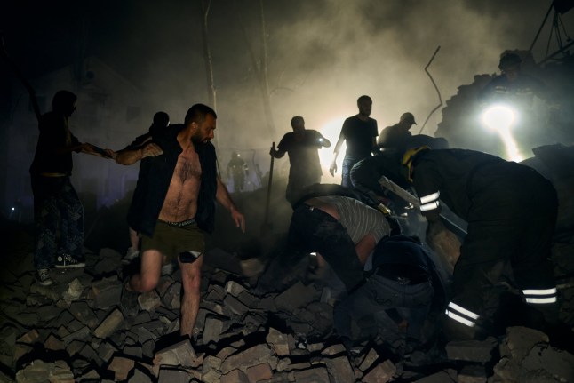 KYIV, UKRAINE - APRIL 24: Rescuers and civilians worked to pull victims from the rubble of a missile strike on a residential building resulting in two deaths and 54 injured on April 24, 2025 in Kyiv, Ukraine. Among the injured were six children and one pregnant woman (Photo by Kostiantyn Liberov/Libkos/Getty Images) *** BESTPIX ***