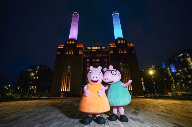 EMBARGOED TO 0001 FRIDAY APRIL 25 EDITORIAL USE ONLY 'Mummy Pig' and 'Daddy Pig' from television series Peppa Pig, at Battersea Power Station in London, as the chimneys are lit up blue and pink ahead of Mummy Pig's baby gender reveal party later today. Issue date: Friday April 25, 2025. PA Photo. The animated show has told the story of Peppa, who lives with Daddy Pig, Mummy Pig, and her little brother George for more than twenty years, with the arrival of a new sibling being the first big change to the pig family in the show's history. The gender of Peppa and George's new sibling will be announced later today. Photo credit should read: Ian West/PA Media Assignments